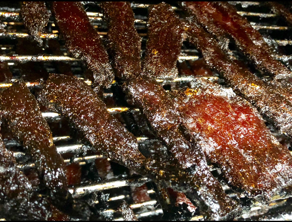 Close-up of jerky on a grill grate