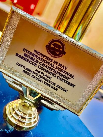 Gold trophy with engraved text at the Memphis International Festival World Championship Barbecue Cooking Contest