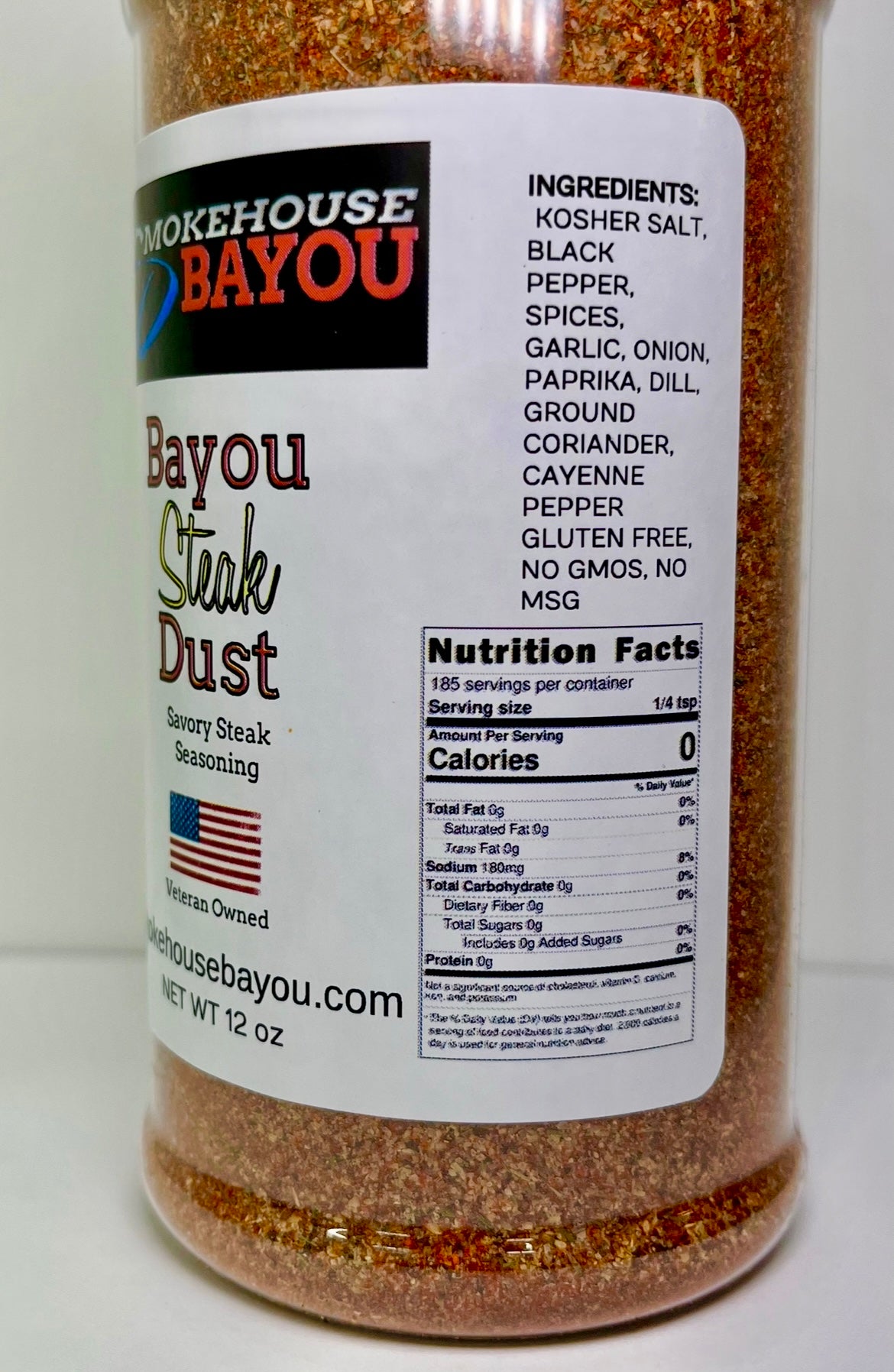 Bottle of Bayou Steak Dust seasoning with label on a white background