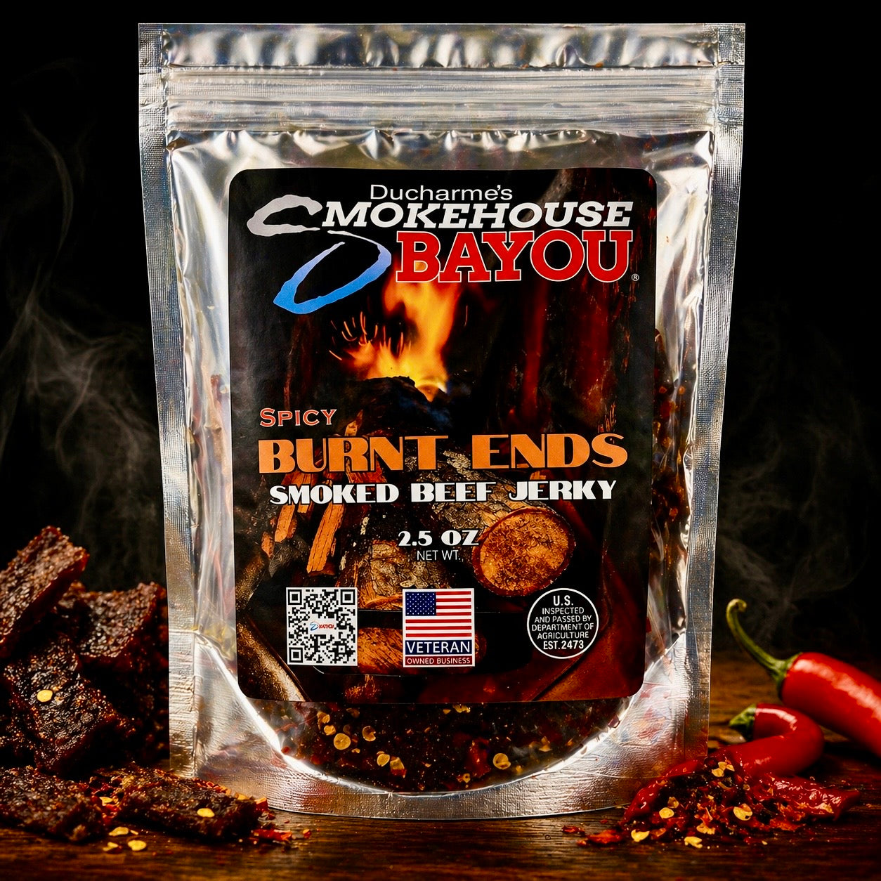 Smokehouse Bayou Spicy Burnt Ends smoked beef jerky package with jerky pieces and red peppers on rustic wood