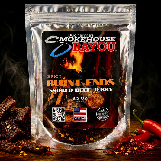 Smokehouse Bayou Spicy Burnt Ends smoked beef jerky package with jerky pieces and red peppers on rustic wood