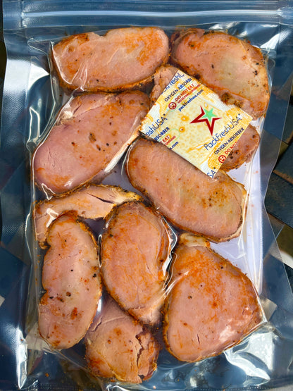 Vacuum-sealed package of sliced sausages with a label on a reflective surface