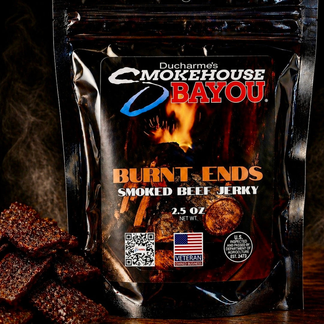 Smokehouse Bayou Burnt Ends smoked beef jerky package with jerky pieces on rustic wood
