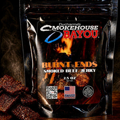Smokehouse Bayou Burnt Ends smoked beef jerky package with jerky pieces on rustic wood