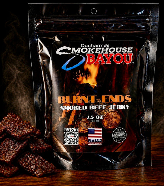 Smokehouse Bayou Burnt Ends smoked beef jerky package with jerky pieces on rustic wood